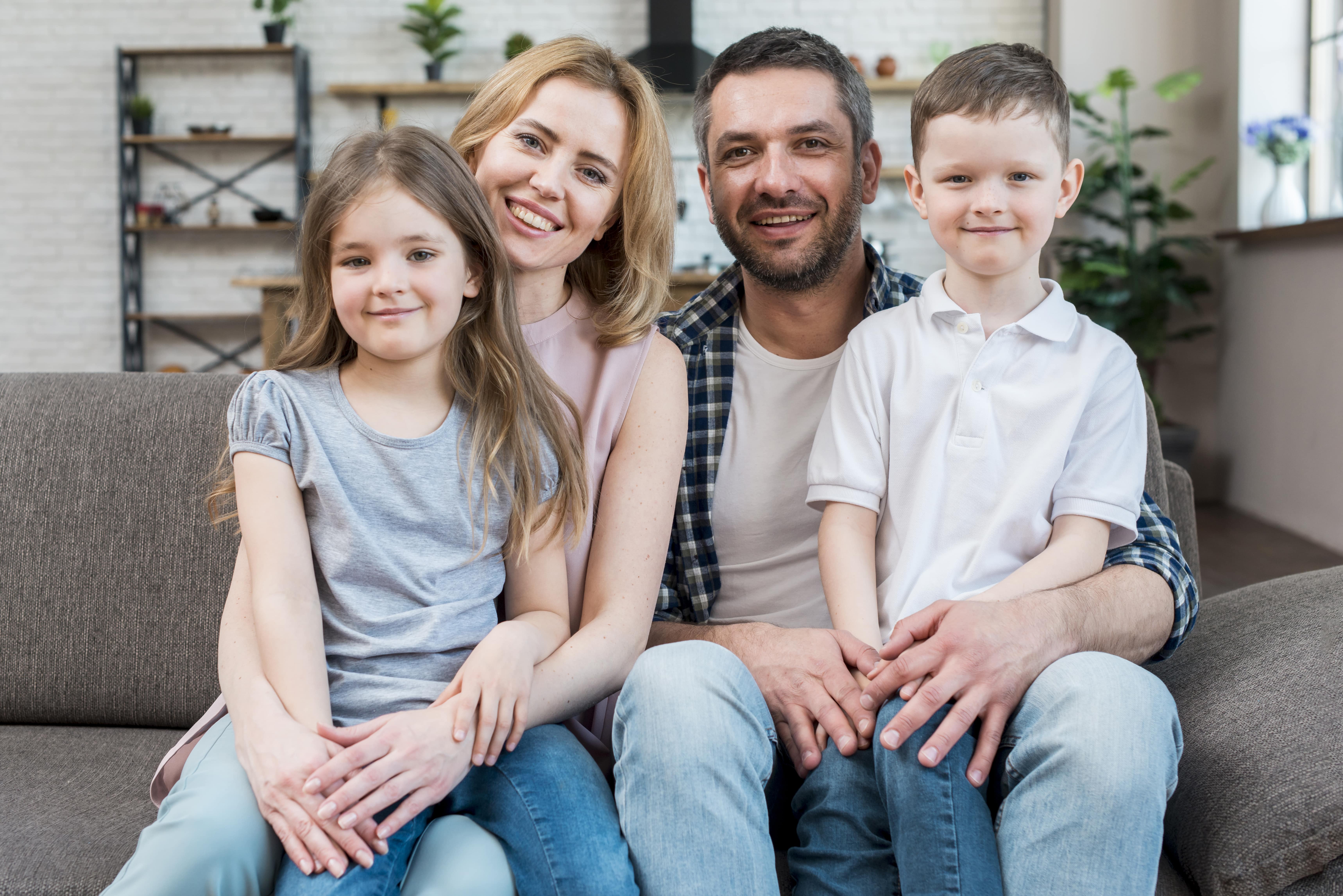happy family smiling together, professional photography, bright lighting, soft colors, warm and inviting, insurance concept